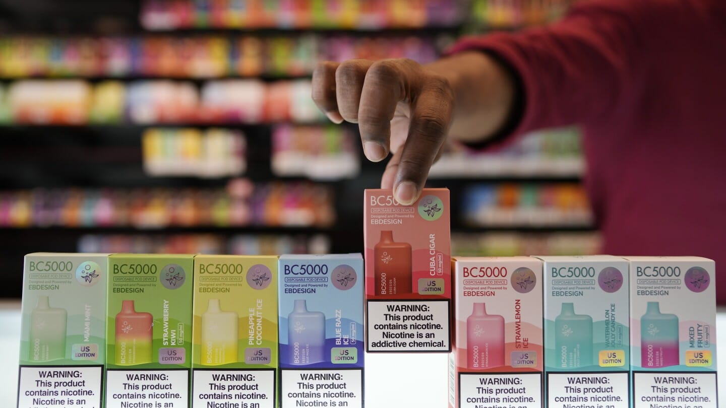 A retail store owner managing inventory of disposable vapes sourced from a reliable wholesaler.